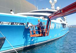 Yacht hull wrapped by LuxWrap from cherry picker