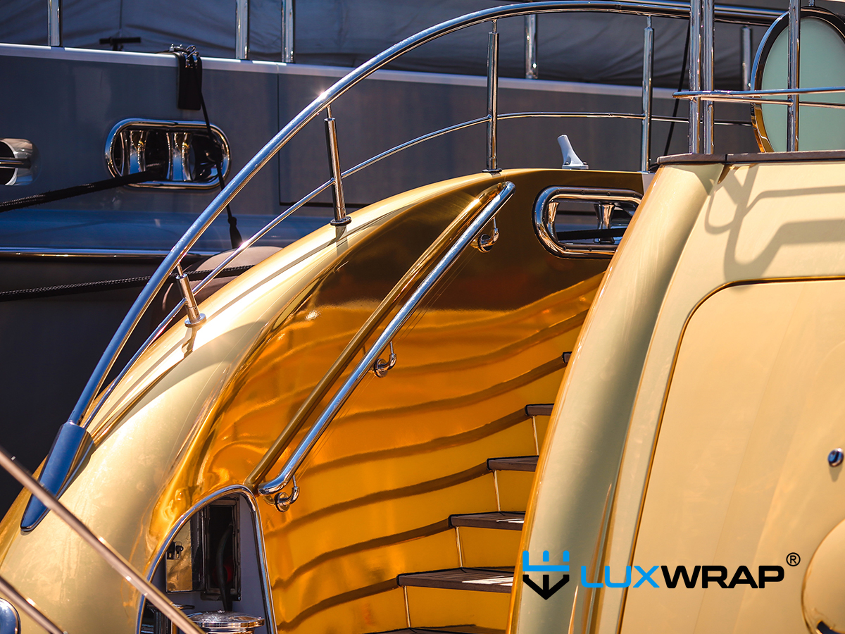 Gold chrome yacht wrap detail on stairway showing luxury superyacht vinyl wrapping finish
