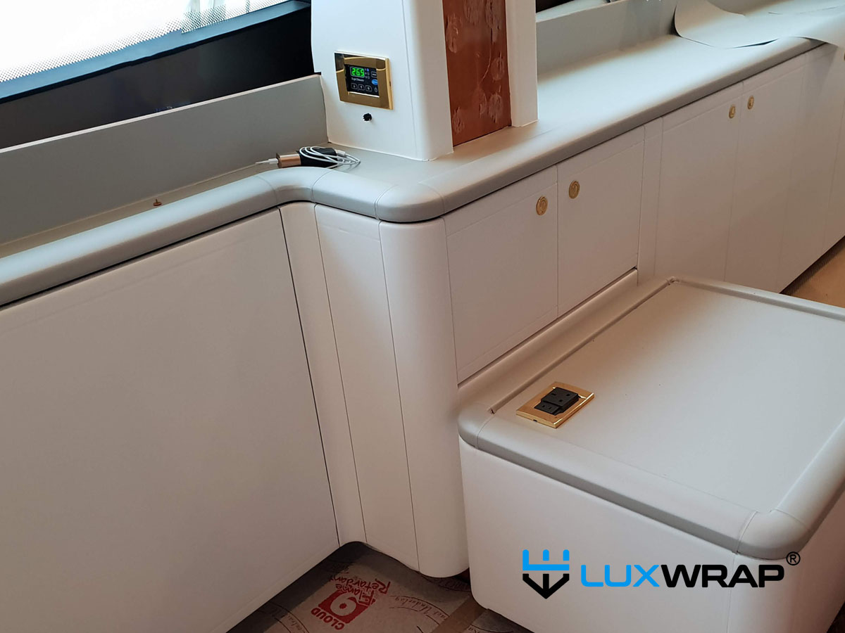 LuxWrap applying leather-texture 3M DI-NOC architectural film to yacht interior panels