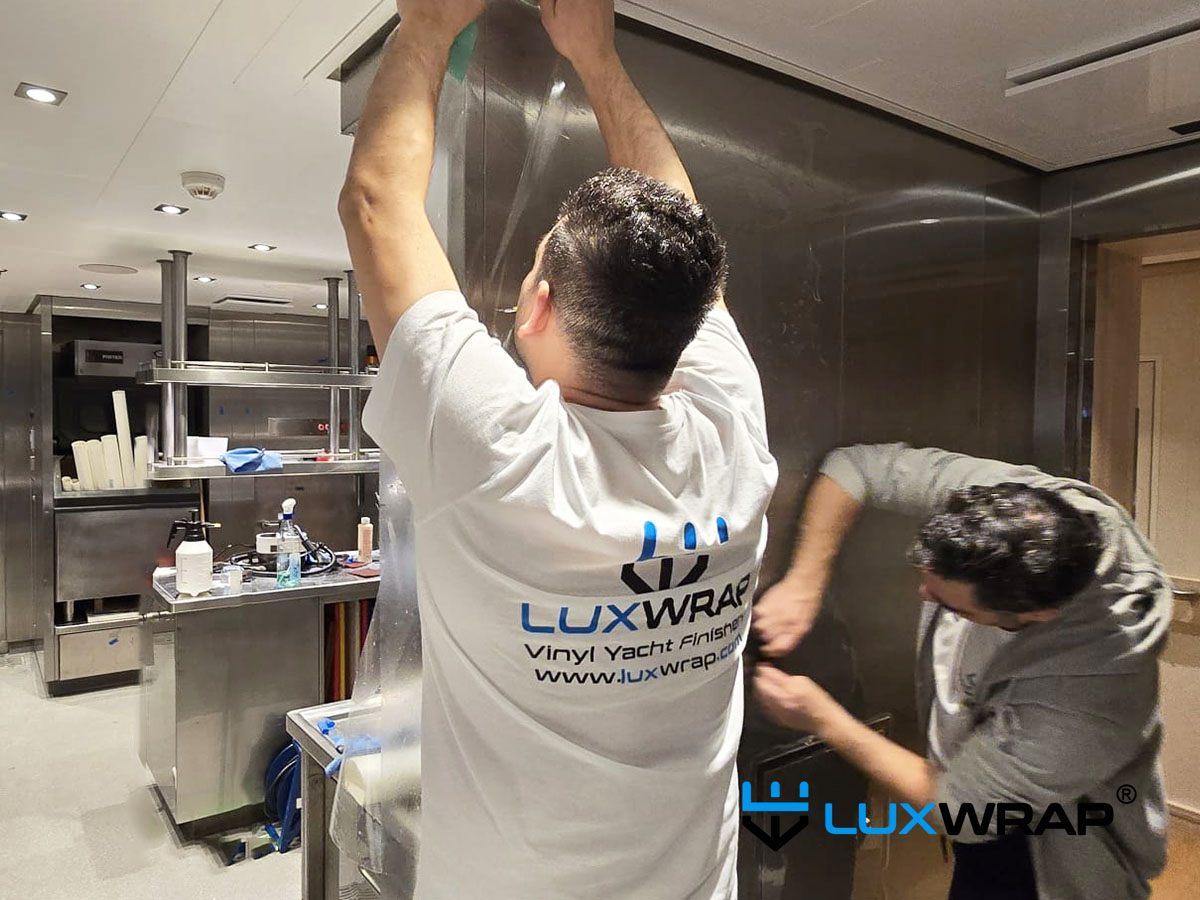 LuxWrap installation in progress — superyacht galley wrap in clear gloss ppf.