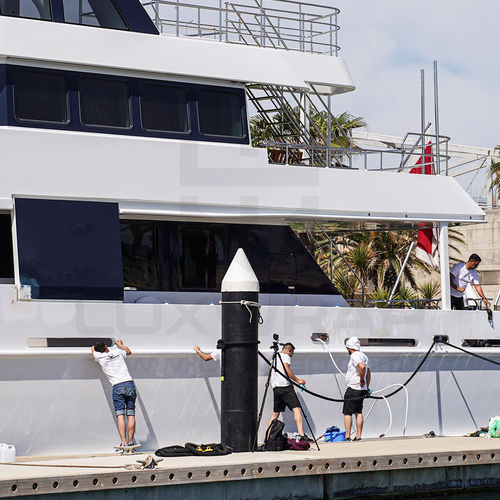 LuxWrap team wrapping the hull and superstructure of a 43m Heesen superyacht in sparkling metallic white vinyl