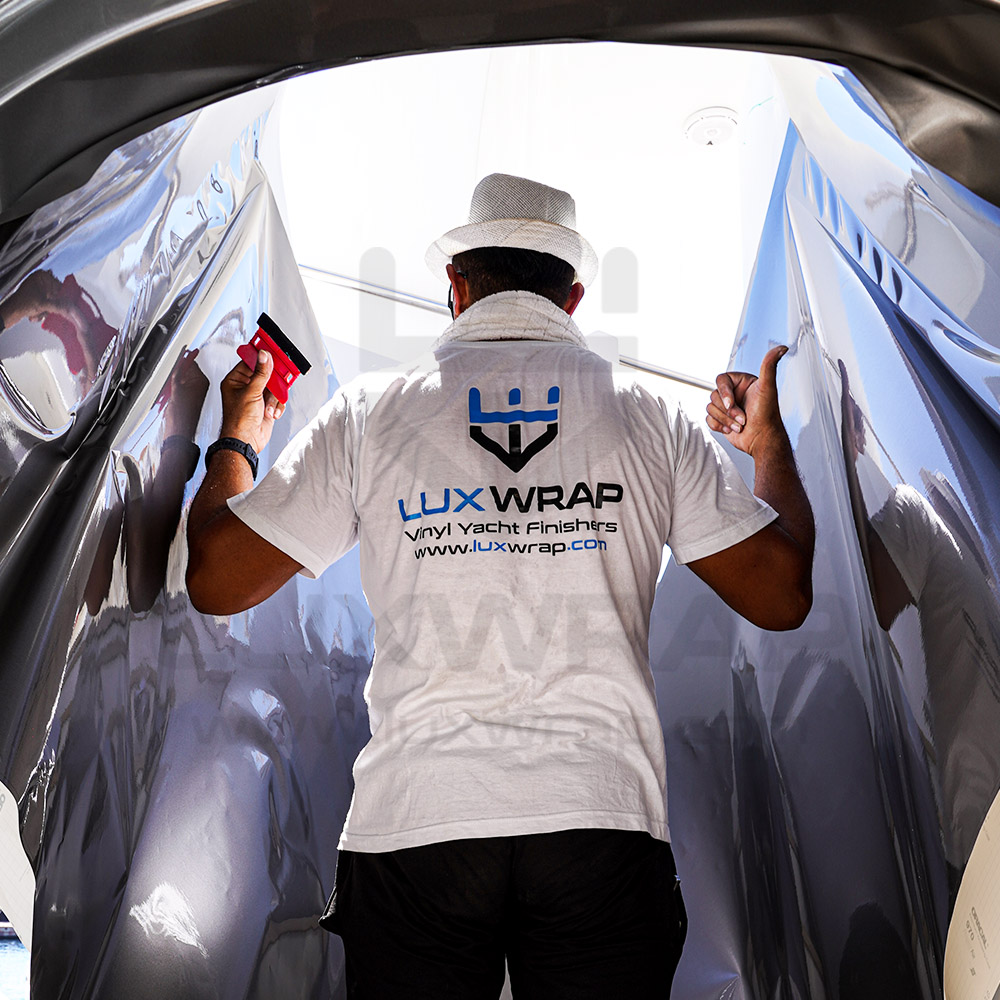 Silver superstructure wrap installation on a 47m Swiftships superyacht — LuxWrap 21-day in-water project