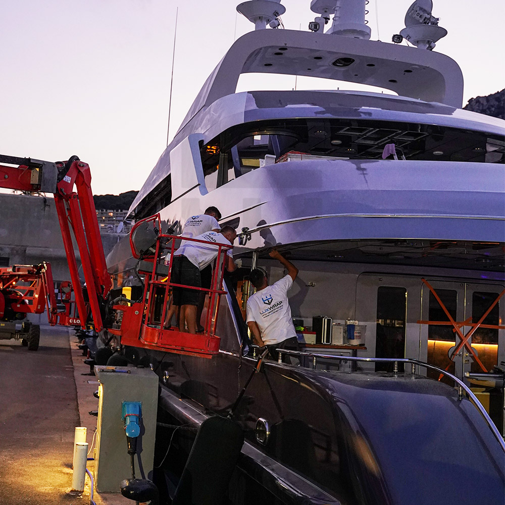 47m Swiftships superyacht hull wrap approaching completion — anthracite vinyl and black window accents by LuxWrap
