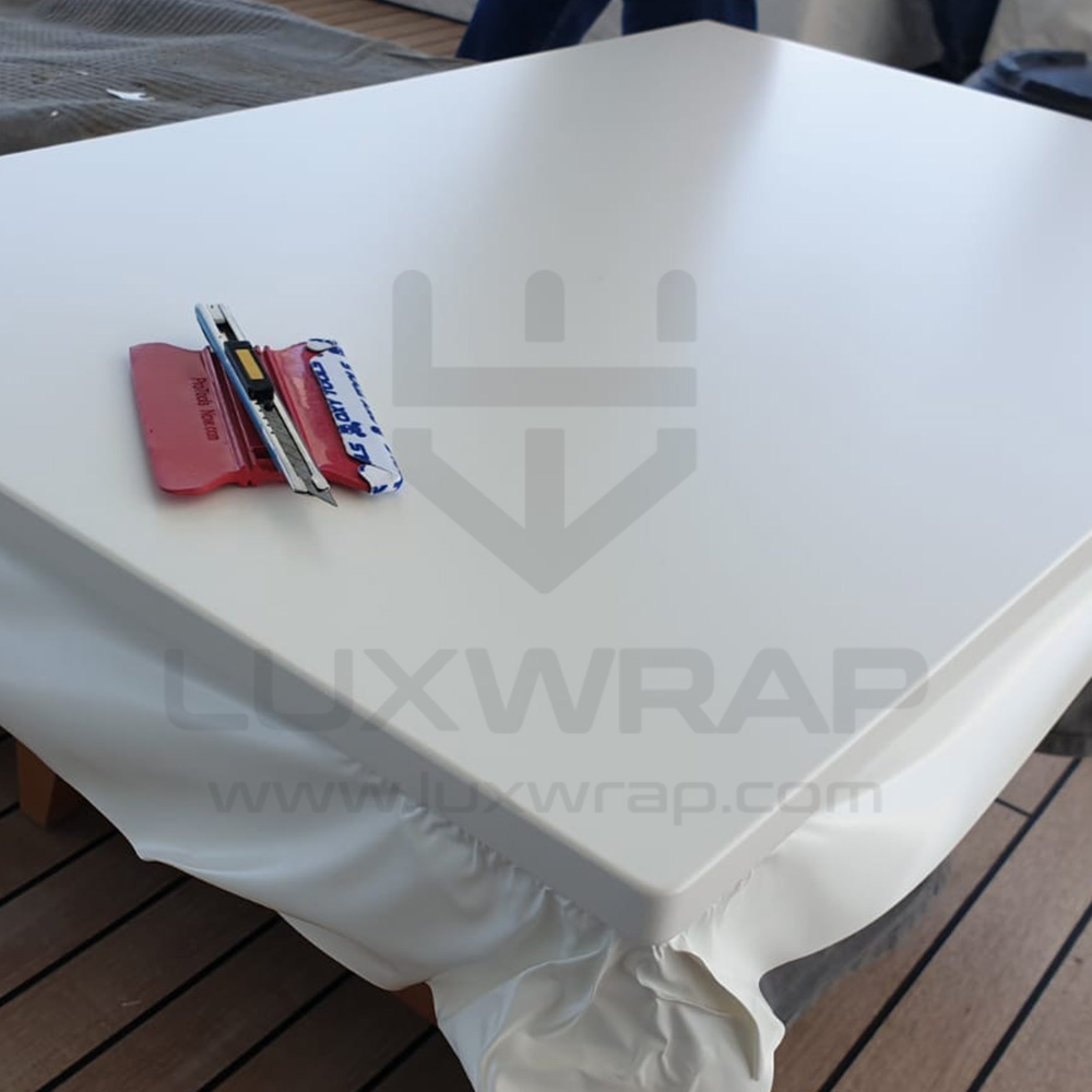 Satin-white vinyl deckhead wrap in progress on a 57m Benetti — clean consistent finish without painting by LuxWrap